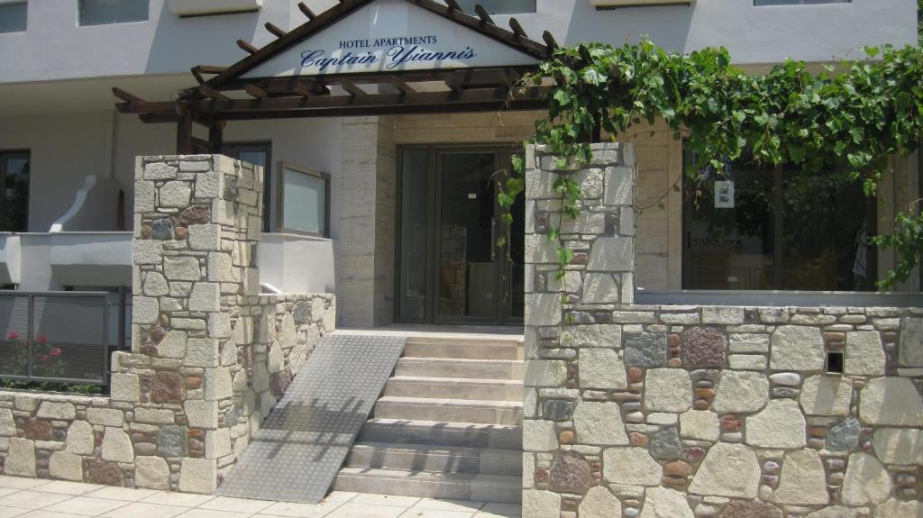a entrance to a building with a stone wall at Captain Yiannis Studios & Apartments in Kos