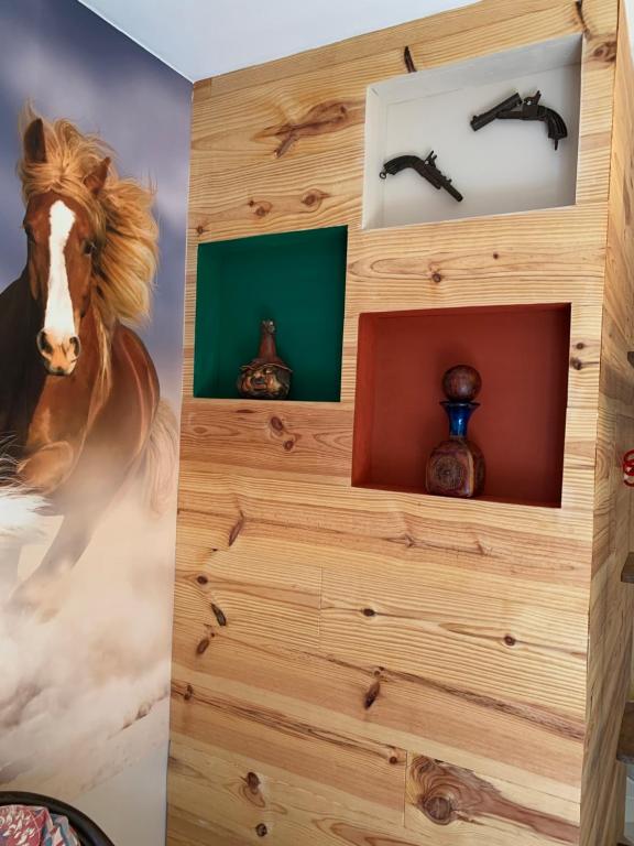 a room with a wooden wall with a painting of a horse at Carpe Diem in Jumet