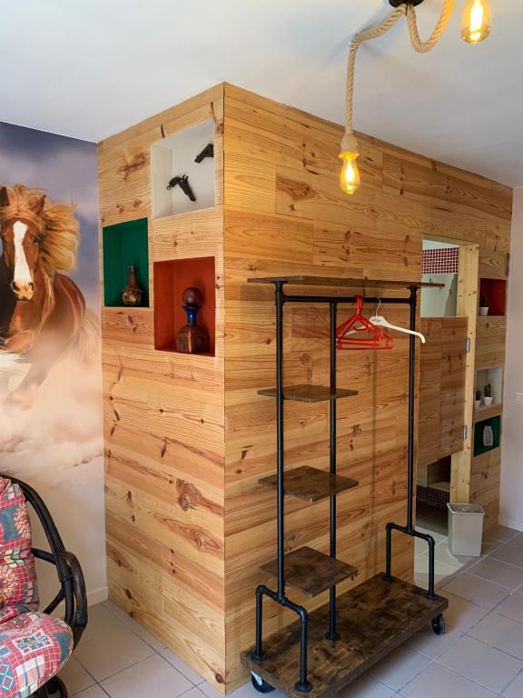 a room with a wooden wall with a book shelf at Carpe Diem in Jumet