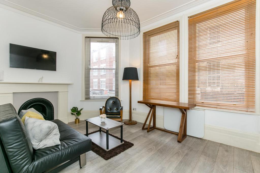 a living room with a couch and a table at Radio Apartments London - Covent Garden in London