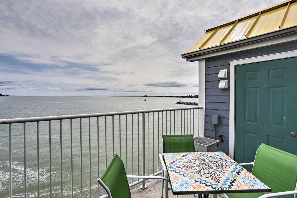 a balcony with a table and chairs and the ocean at Resort-Style Condo with Lake-View Balcony! in Put-in-Bay