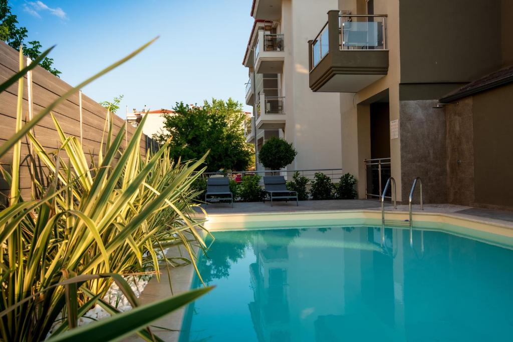 a swimming pool in front of a building at OLIVE 102 in Perea