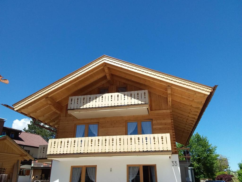 a wooden house with a balcony on top of it at Ferienwohnungen Satzger in Mittenwald