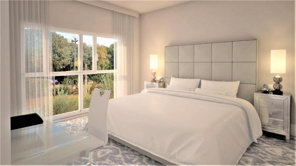 Postel nebo postele na pokoji v ubytování Royal Palm Hotel