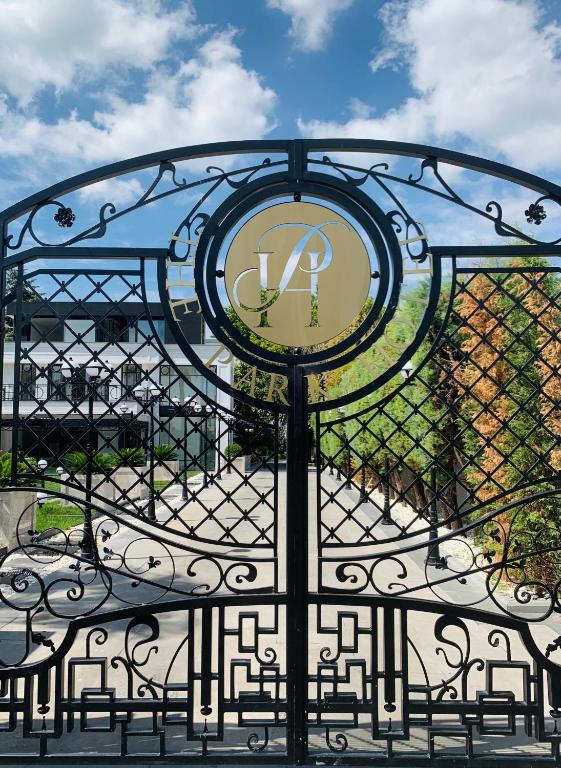 a wrought iron gate with a clock on it at Istanbul Park Hotel in Tuzla