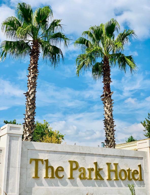 two palm trees behind a sign at the park hotel at Istanbul Park Hotel in Tuzla