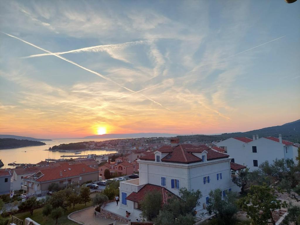 a view of a town with the sunset in the background at Luxury Landing in Cres