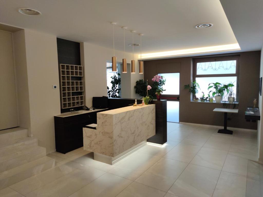 a lobby with a reception desk in a building at Hotel Emiliana in Villadossola