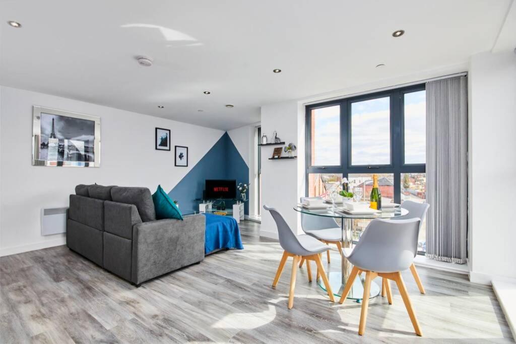 un soggiorno con divano, tavolo e sedie di Stylish 2 Bed Apartment with Free parking, close to City Centre by Hass Haus a Manchester