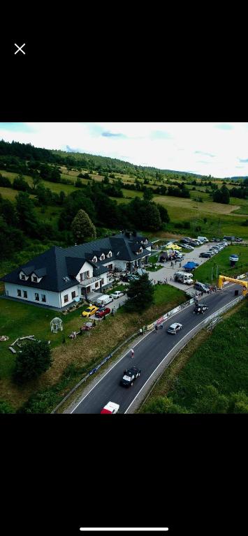 an aerial view of a town with cars on a road at Gospoda Magurska in Sękowa