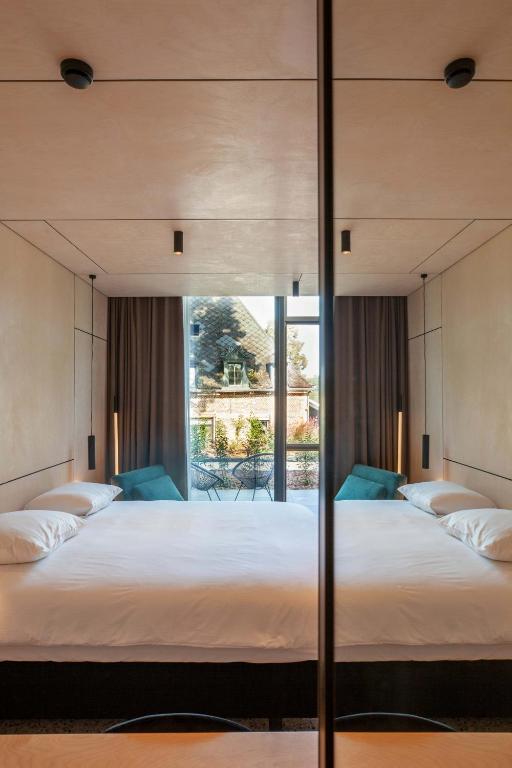 Ένα ή περισσότερα κρεβάτια σε δωμάτιο στο Hotel The Lodge Heverlee