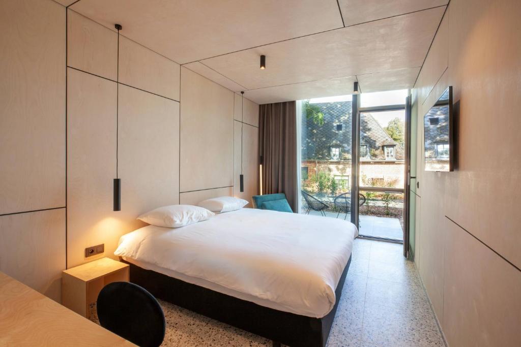 Ένα ή περισσότερα κρεβάτια σε δωμάτιο στο Hotel The Lodge Heverlee
