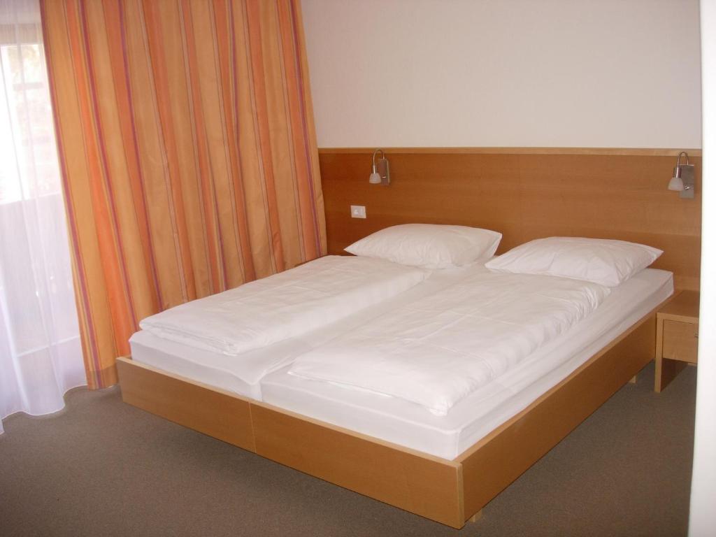 Postel nebo postele na pokoji v ubytování Garni Kofler