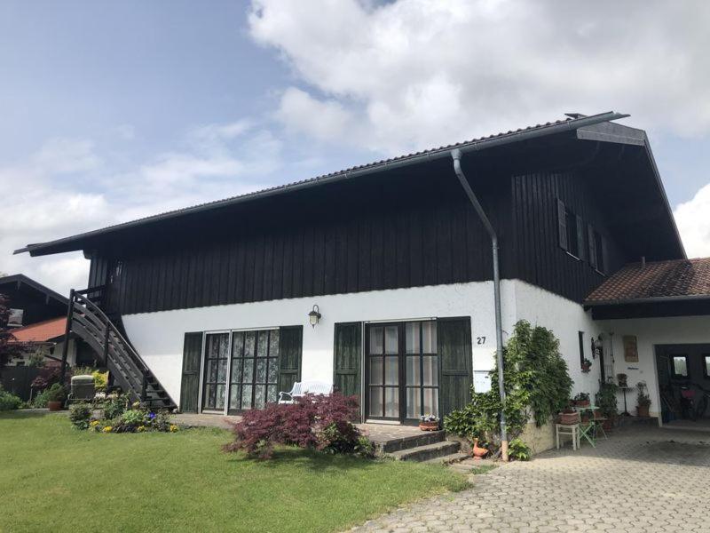 a black and white house with a grass yard at Hofmann Judith in Grassau