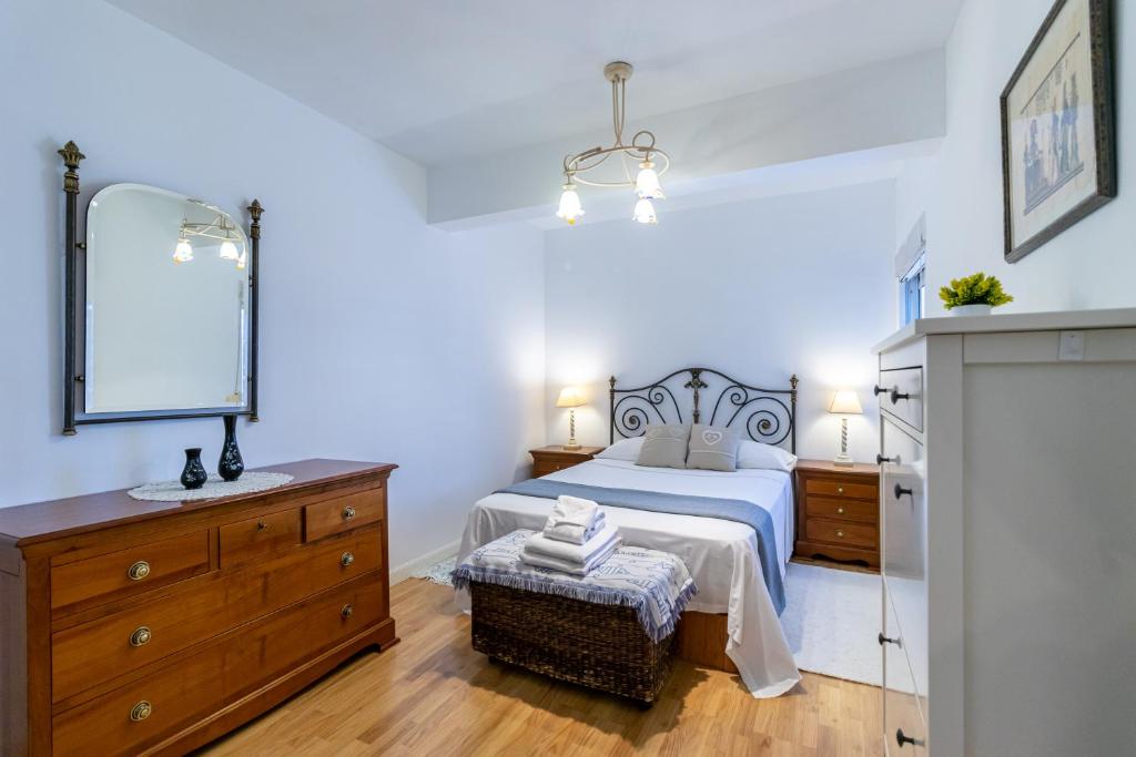 a bedroom with a bed and a sink and a mirror at Ifema Aeropuerto in Madrid