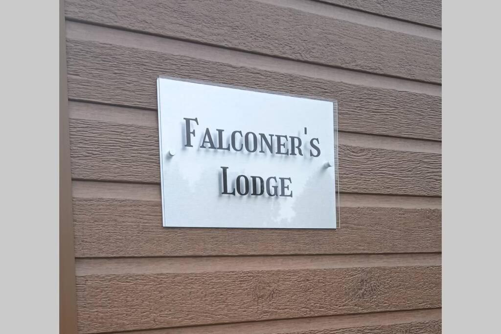 a sign on the side of a house at Falconers Lodge with Hot Tub in Barmby on the Moor