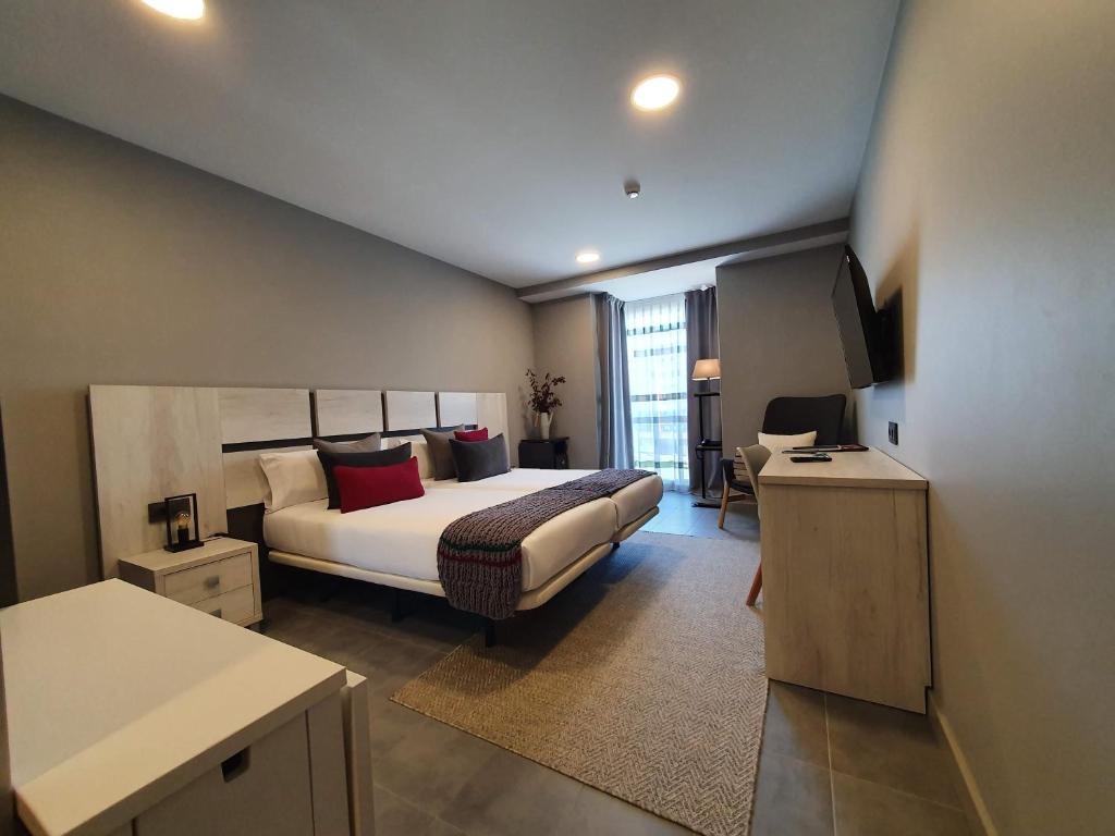 a hotel room with a bed and a desk at Apartahotel 5dos5 in Oviedo