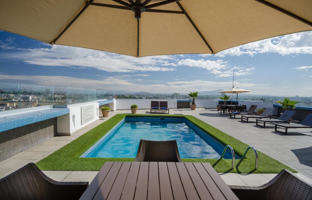 a swimming pool on the roof of a building at Best Western Plus Gran Hotel Centro Historico in Guadalajara