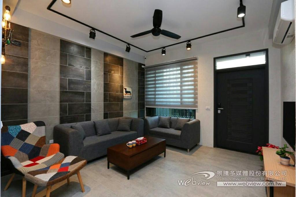 a living room with a couch and a ceiling fan at 蘭陽河畔居二館 in Yilan City
