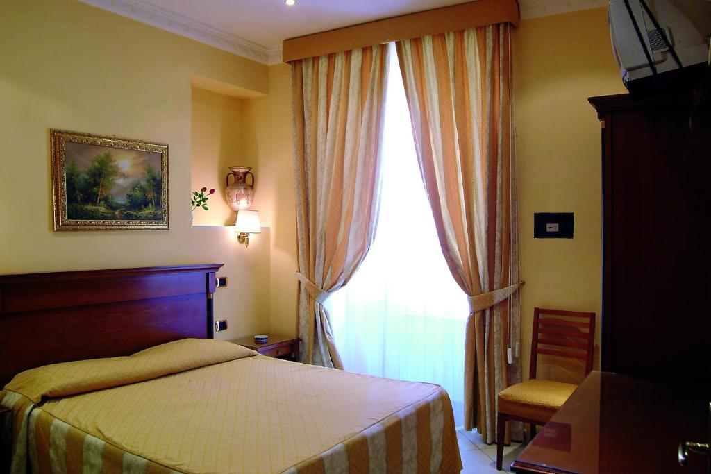 a bedroom with a bed and a large window at Hotel Meridiana in Rome