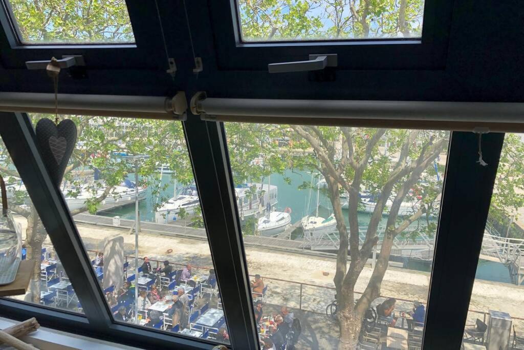 a view from a window of a marina with boats at le Gabut vue port in La Rochelle