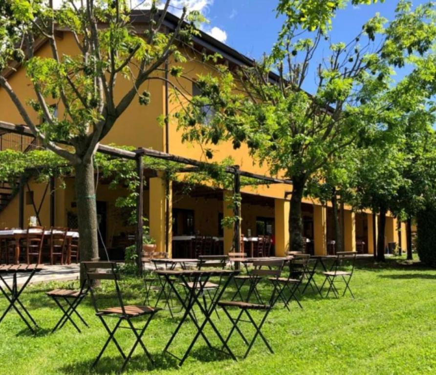 a group of tables and chairs in front of a building at Cascina Bosco Gerolo in Rivergaro