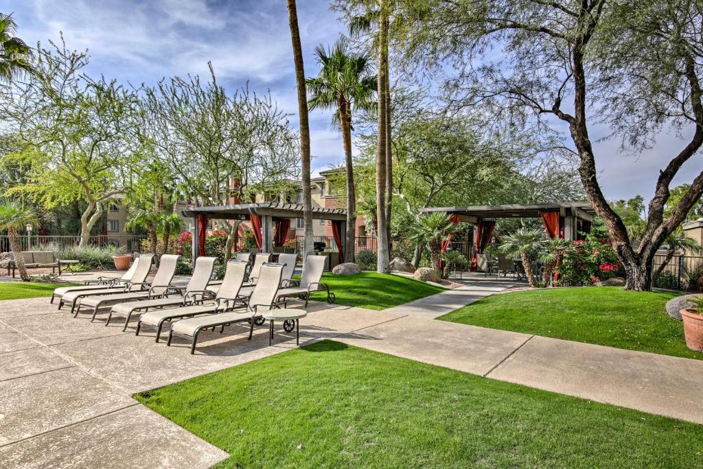 a group of white lounge chairs in a park at Red Rox Phoenix Condo with Patio about 3 Mi to Airport in Phoenix