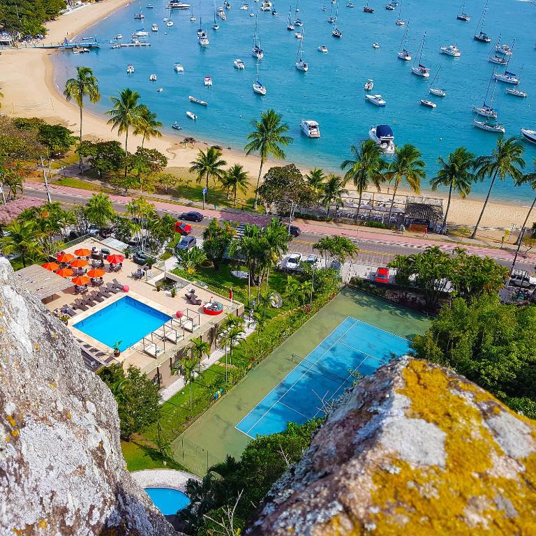 an aerial view of a resort with a beach and boats at Hotel Itapemar - Ilhabela in Ilhabela