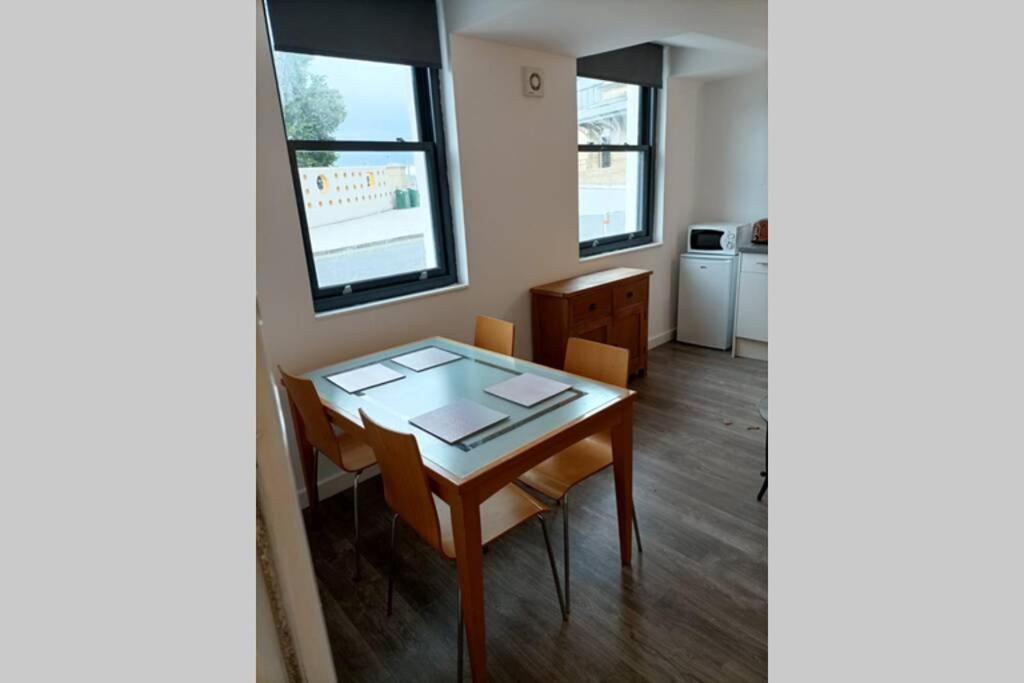 a dining room with a table and some chairs at Spacious one bedroom family apartment -non smoker in Wakefield