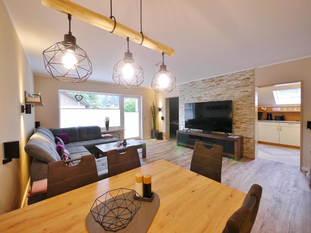 a living room with a table and a couch at Fewo Steingrotte (inkl. MeineCard+) in Willingen