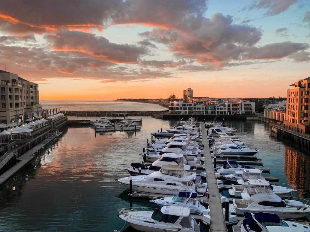 a group of boats are docked in a harbor at Watercolours on Marina in Glenelg