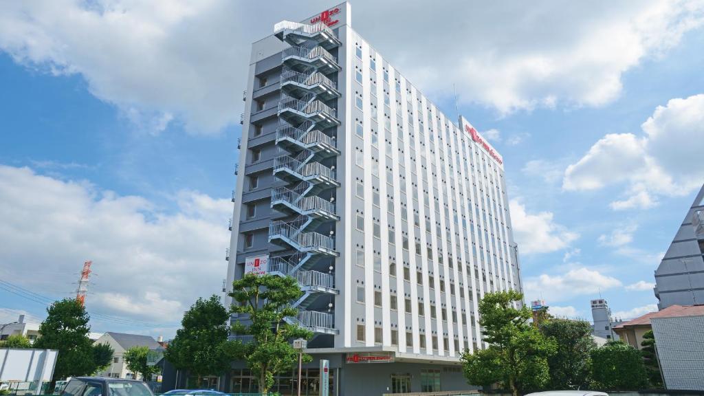 a tall white building with a lot of windows at UNIZO INN Express Utsunomiya in Utsunomiya