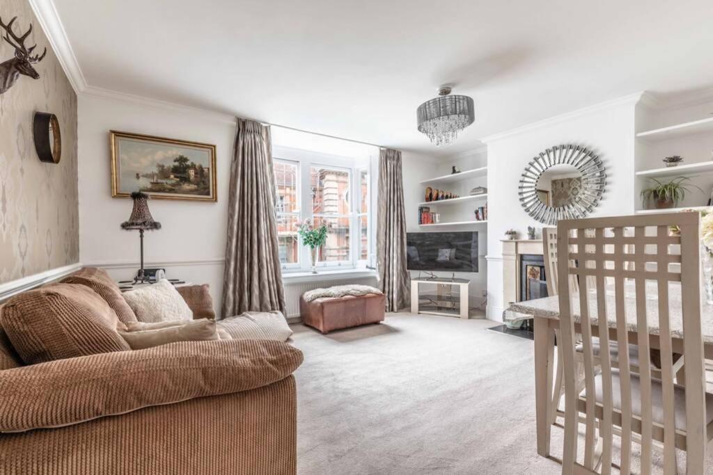 a living room with a couch and a chair at Windsor Town Centre Victorian townhouse sleeps 6 in Windsor