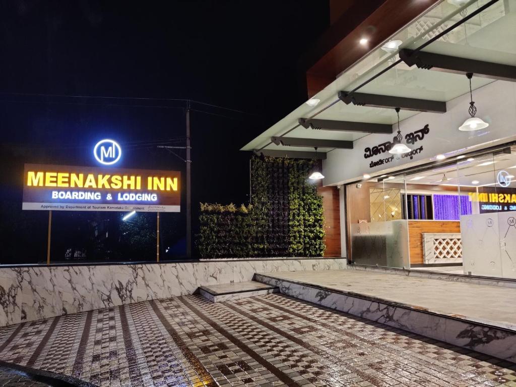 a store front with a sign on the wall at Meenakshi Inn in Udupi