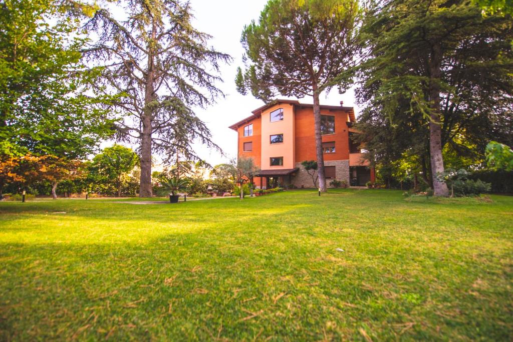a house in the middle of a field with trees at B&B Il Girasole in Corciano