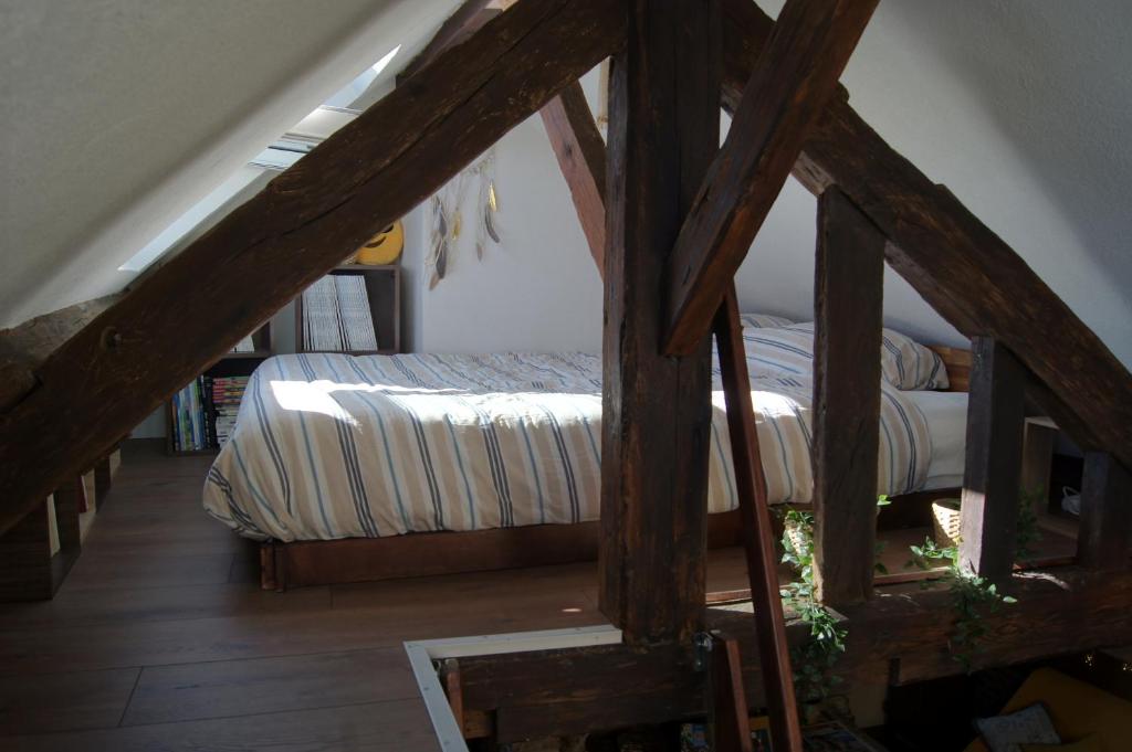 a bedroom with a bed in a attic at Le perchoir de St-Antoine in Honfleur