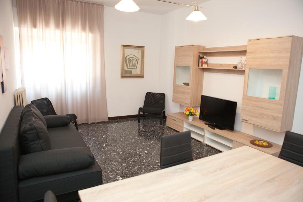 a living room with a couch and a television at Maipiusenza House in Monopoli