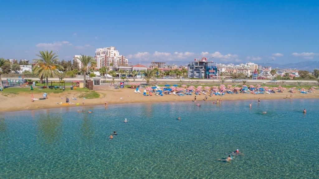 a group of people in the water at a beach at Ceasar Resort Cyprus - Apartment Leona in Bahçeler