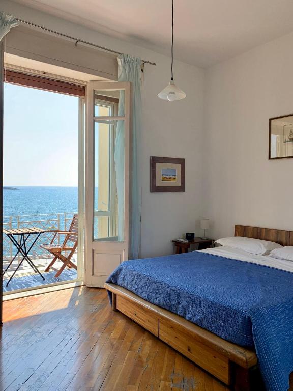 a bedroom with a bed and a view of the ocean at Mare Blu in Sapri