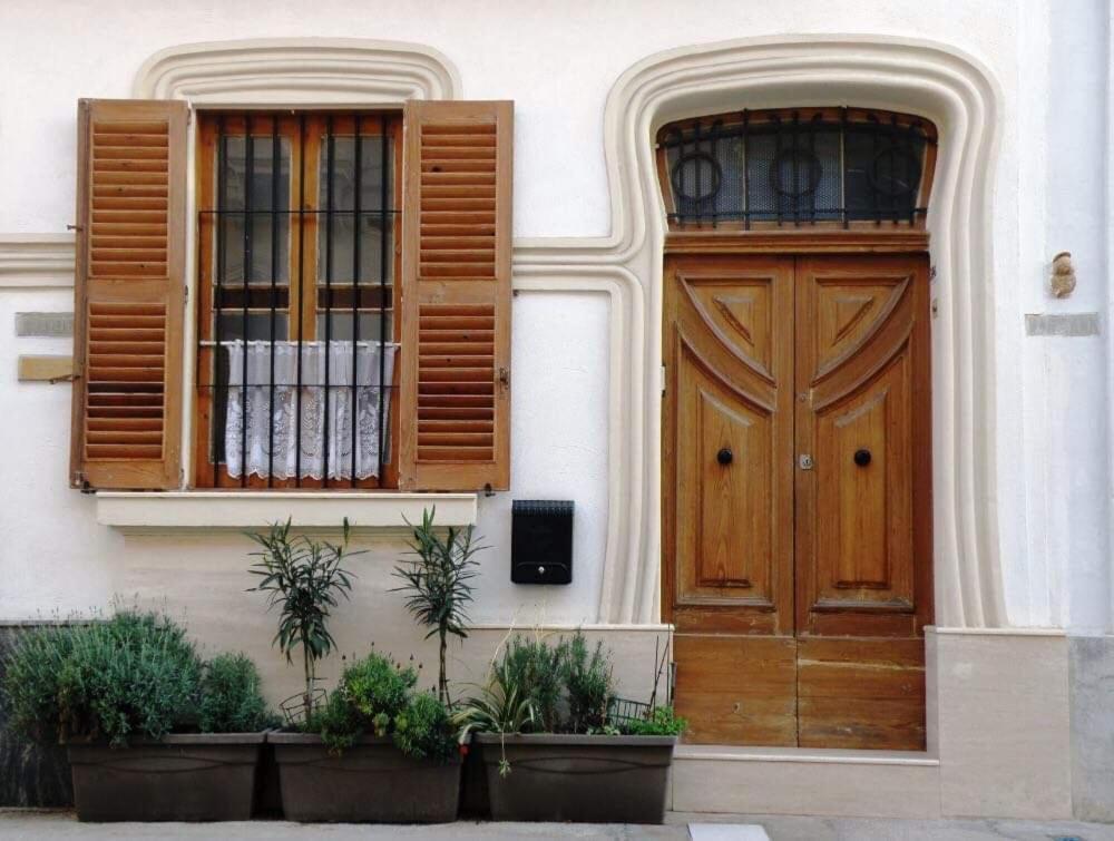 a building with a wooden door and two windows at Pawlu Accommodations in Sliema