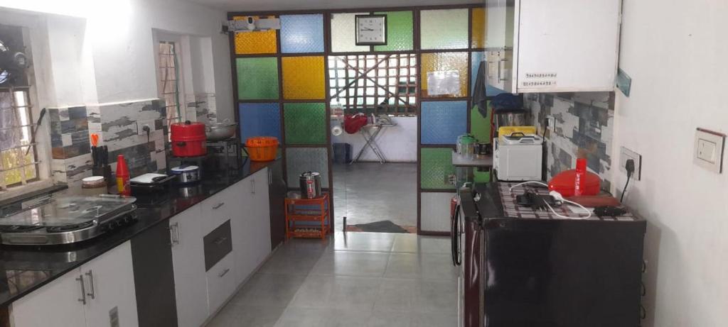 a kitchen with colorful tiles on the wall at Nature Villa Kochi in Alwaye