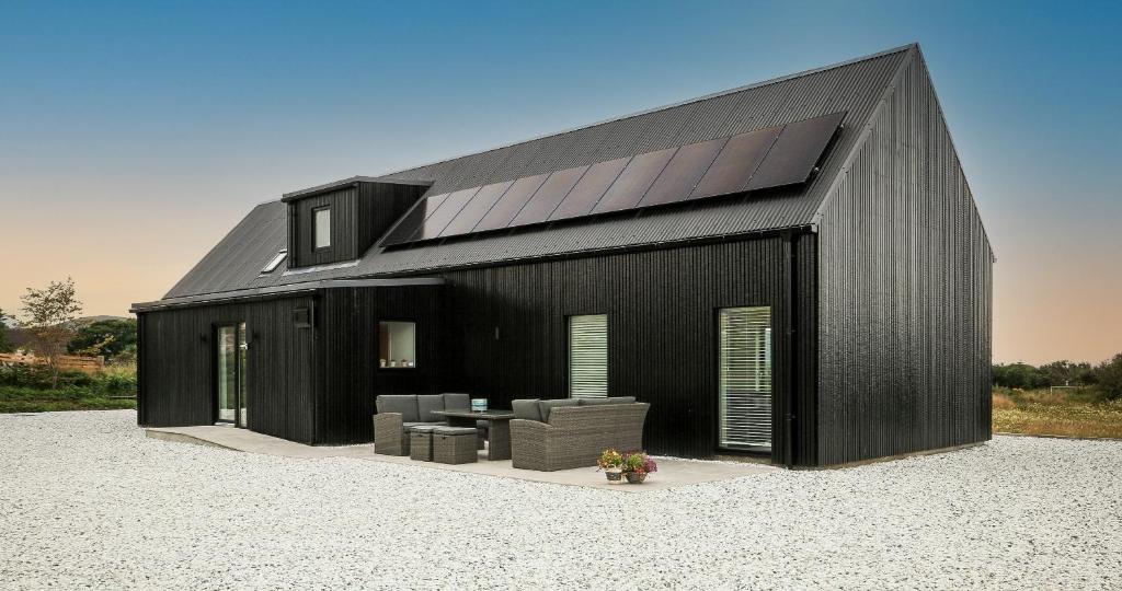 a black house with a black roof at Black Barn Skye - Contemporary 3 bed / 4 bath home in Broadford