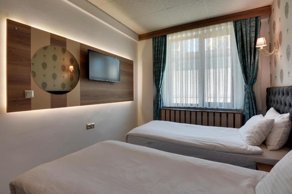 A bed or beds in a room at Grande Stella Hotel
