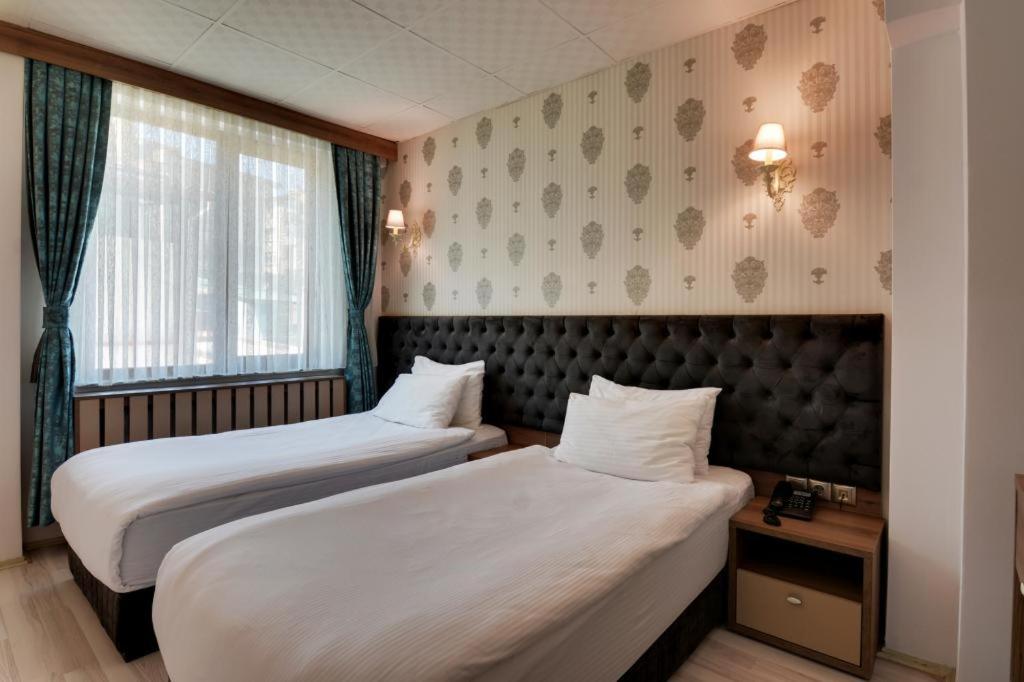 A bed or beds in a room at Grande Stella Hotel