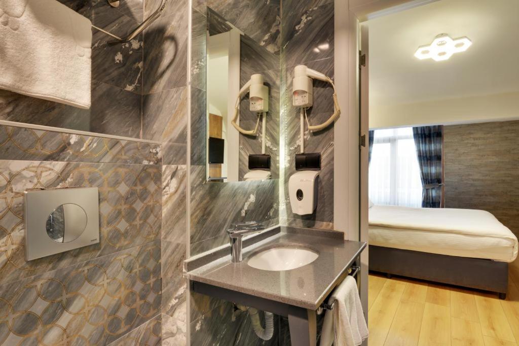 A bed or beds in a room at Grande Stella Hotel