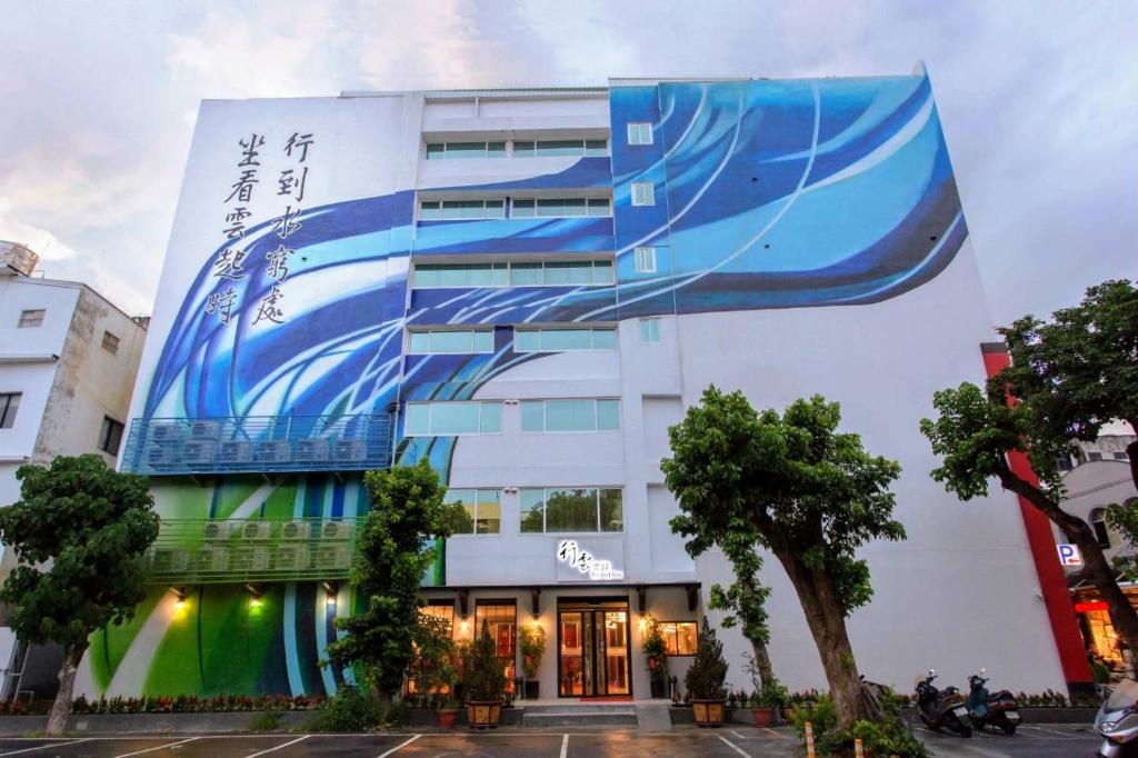 a building with a large painting on the side of it at Seeing Inn in Taitung City