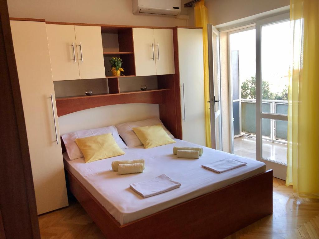 a bedroom with a large bed with two towels on it at Villa Marin- MAKARSKA in Makarska