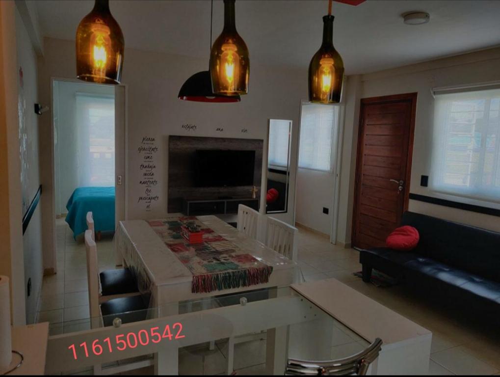 a living room with a table and a fireplace at Alojamiento Luz de Faro, frente a las mejores playas! in Mar del Plata
