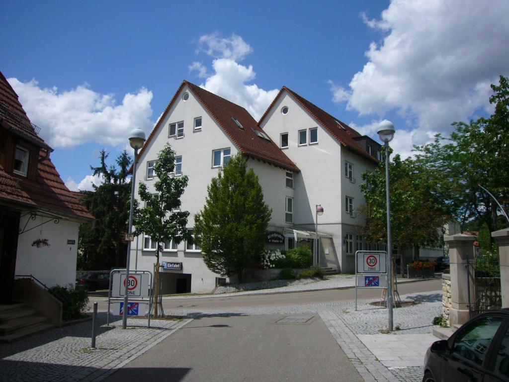 a row of white houses on a street with no parking signs at Hotel Altbacher Hof in Altbach