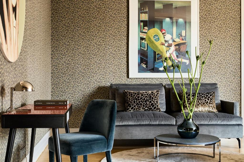 a living room with a couch and a table at H15 Boutique Hotel, Warsaw, a Member of Design Hotels in Warsaw